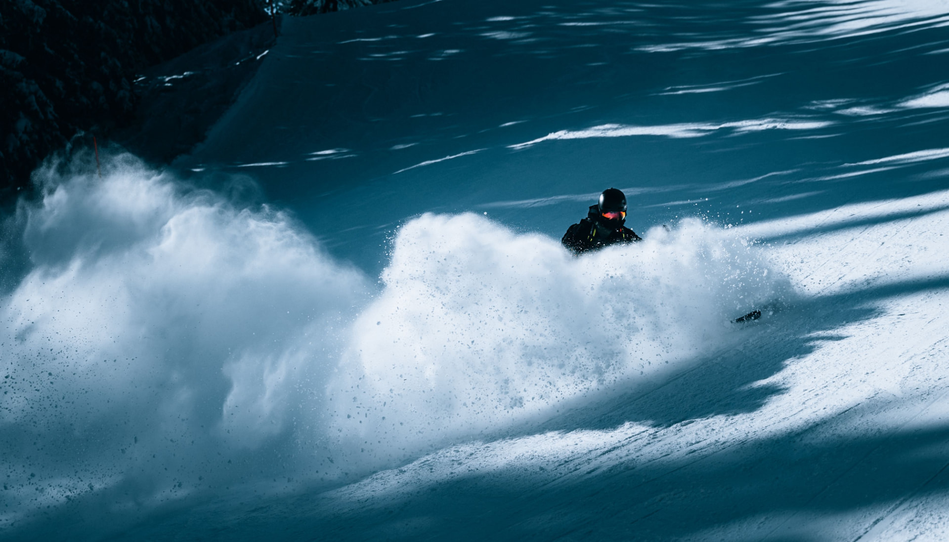 Skier carving through deep powder snow
